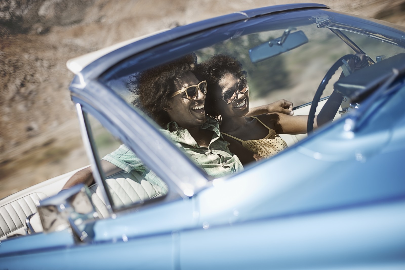 couple in convertible on road trip